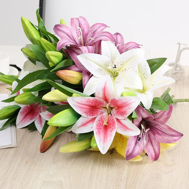 A bouquet of realistic silk lily flowers in shades of pink, white, and purple with green stems.