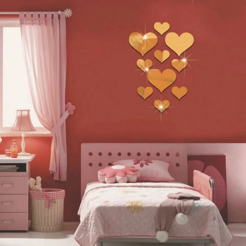 A bedroom wall decorated with a heart mirror wall sticker set featuring gold hearts on a red wall above a bed.