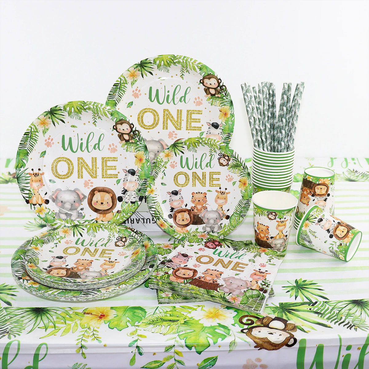 A green and white jungle safari themed tableware set featuring animal prints for a birthday party.