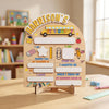 A personalized wooden keepsake board for a child featuring sections for first day of school details like name age and favorit