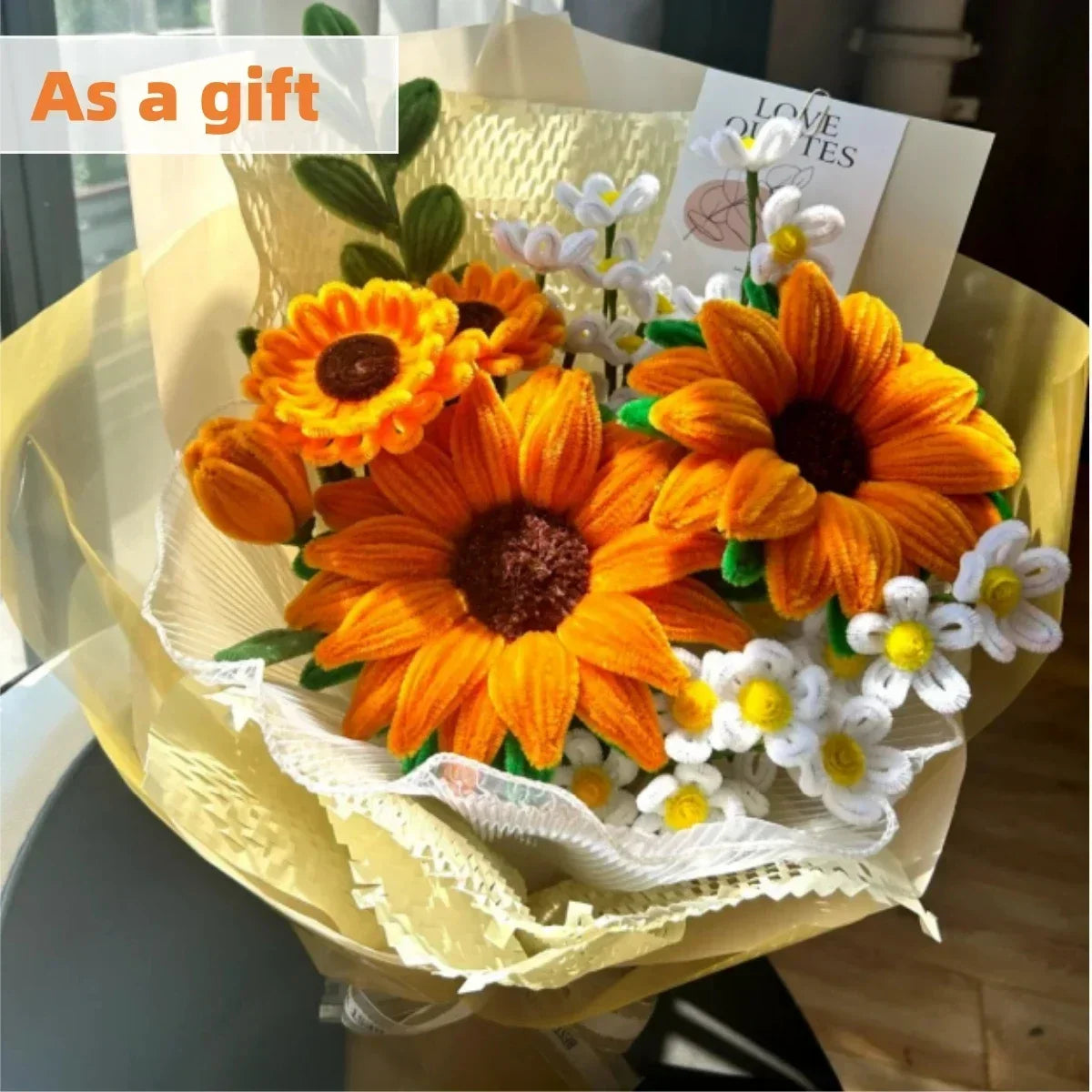 A gift box containing orange and white flowers made from chenille stem pipe cleaners for DIY crafts
