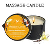 A dark candle in a black jar with an amber vanilla scent and floral decorations.