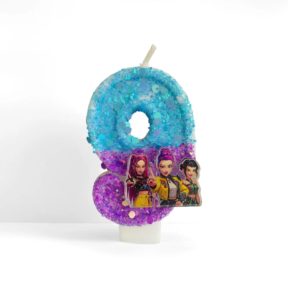 A blue glitter number zero candle decorated with colorful character figures.