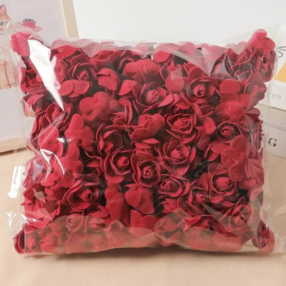 A bag of deep red artificial rose flowers used for DIY decor.