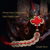 A pendant featuring eight copper coins tied in a Chinese knot, displayed against a dark, rustic background.