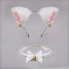 A pair of white faux cat ear headband with pink inner lining and gold bell accents, shown above a white lace bow choker.