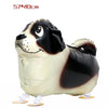 A foil balloon shaped like a black and white dog, used for birthday party decor.