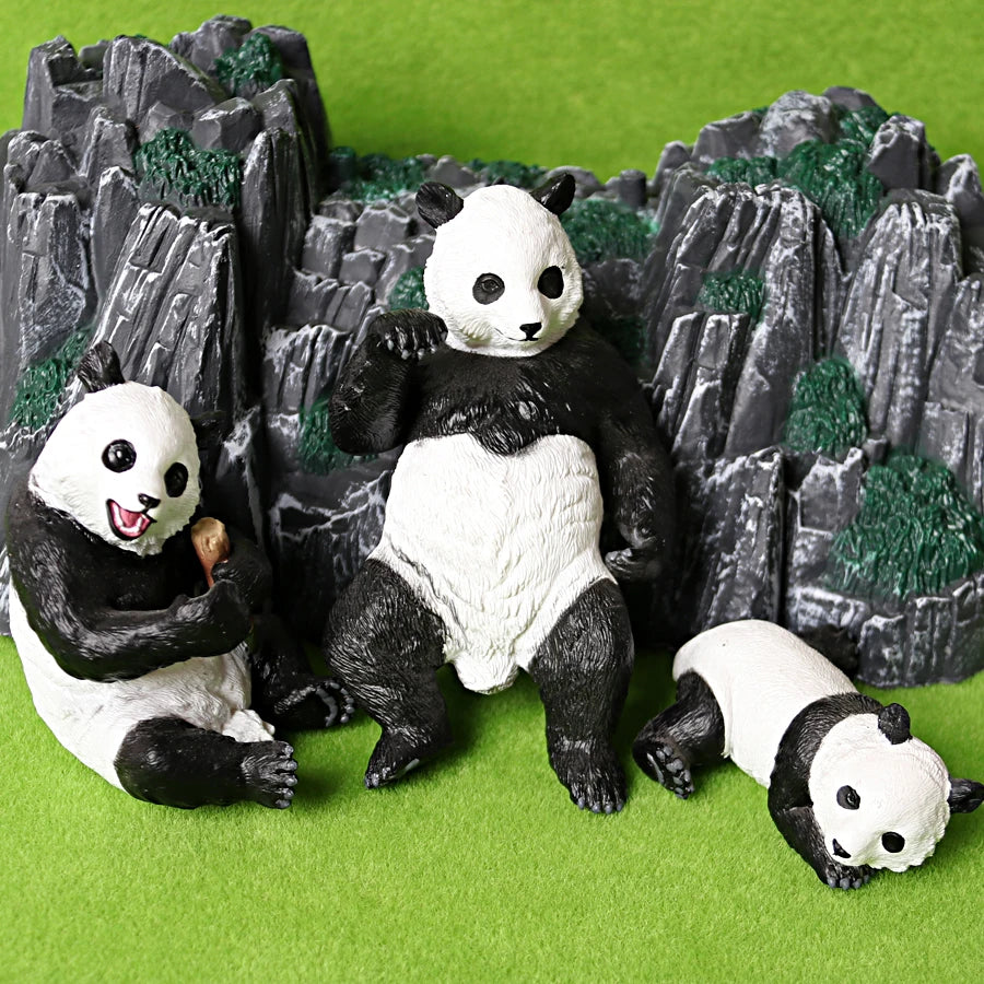 A set of realistic panda life cycle figurines featuring black and white pandas in a rocky green landscape.