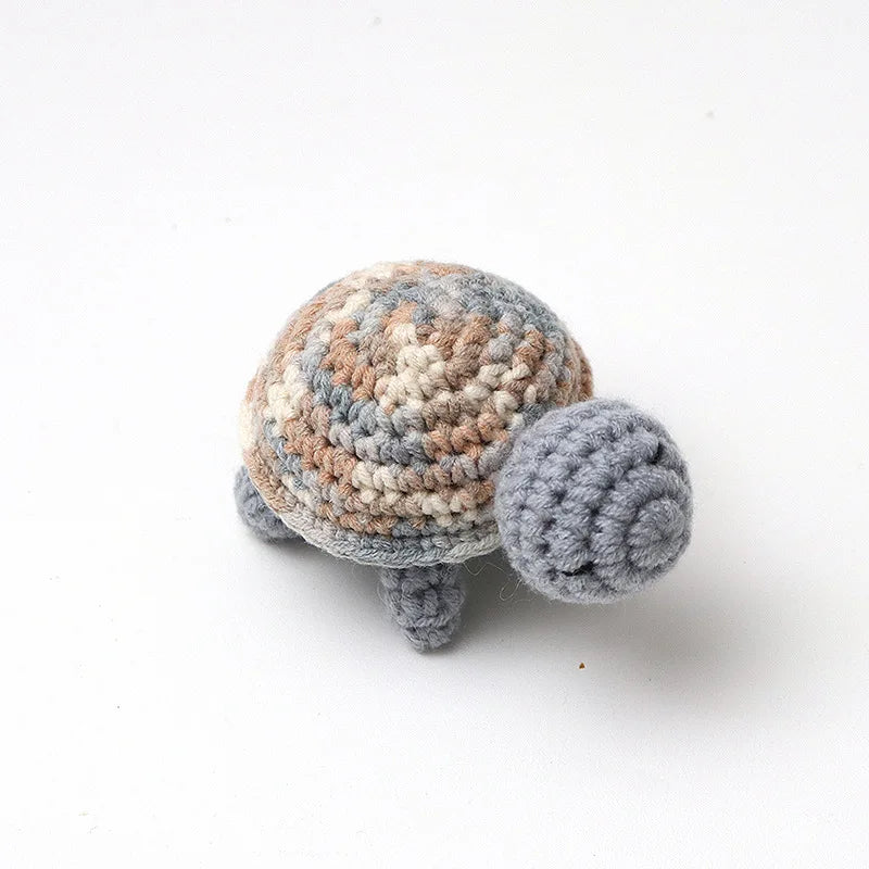 Handmade crocheted turtle plush in shades of brown and gray