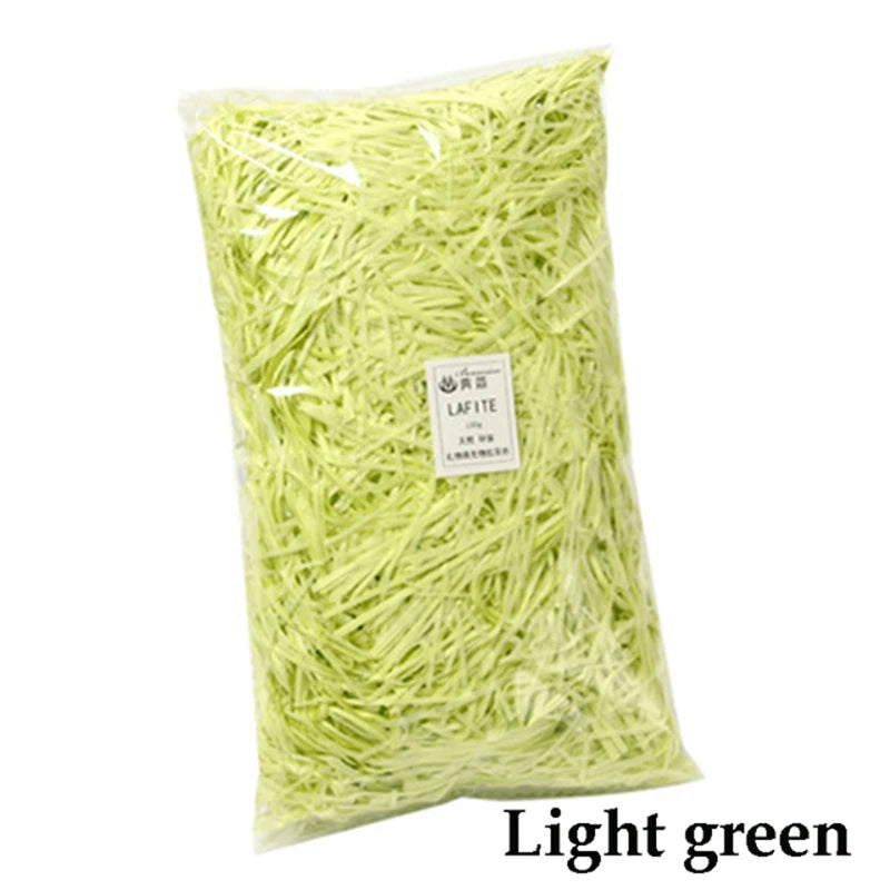 Bag of light green crinkle paper shreds for gift boxes and party decor