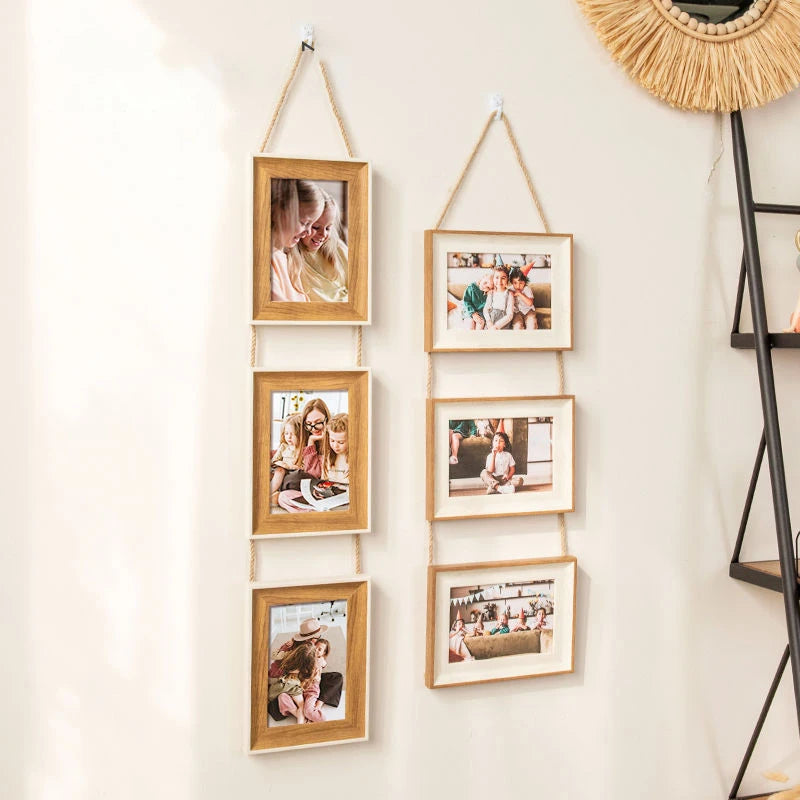 A set of five rustic wooden collage photo frames hanging on a white wall.