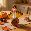 A felt turkey costume shaped like a goose statue with orange and brown feathers on a wooden table.