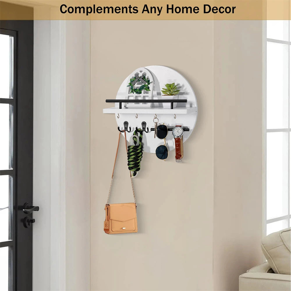 A white circular wooden wall key holder with a shelf displaying various keys and accessories on a beige wall.