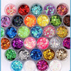 A collection of 32 colorful rainbow glitter mixes in small containers for nail art and DIY crafts.