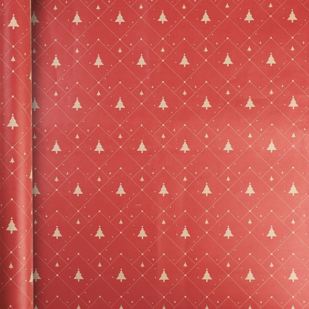 A roll of festive Christmas wrapping paper featuring a red background with a repeating pattern of white Christmas trees and d