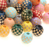 A collection of colorful wooden beads with checkered patterns in various shades of pink, green, yellow, and blue.