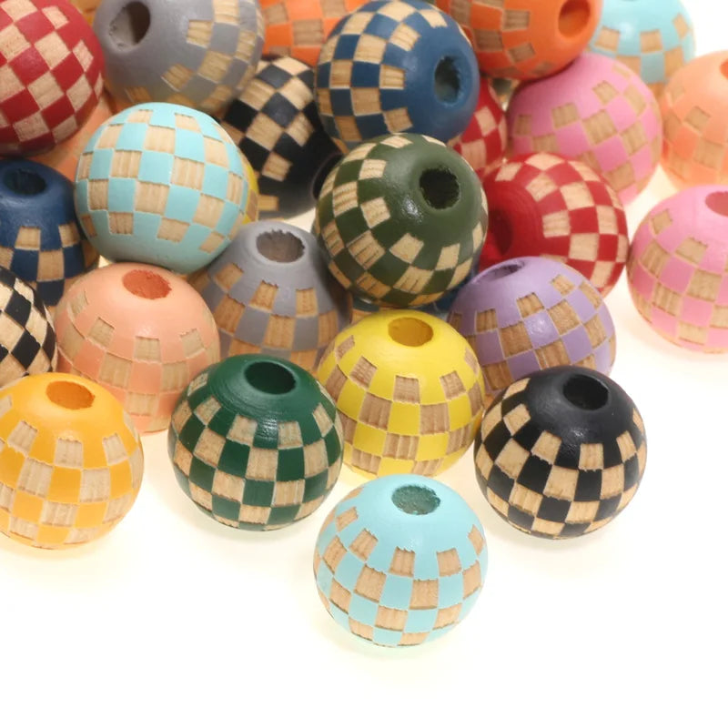 A collection of colorful wooden beads with checkered patterns in various shades of pink, green, yellow, and blue.