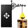 A black gothic bookshelf reading lamp with an ornate wrought iron arm and a warm amber glowing light.
