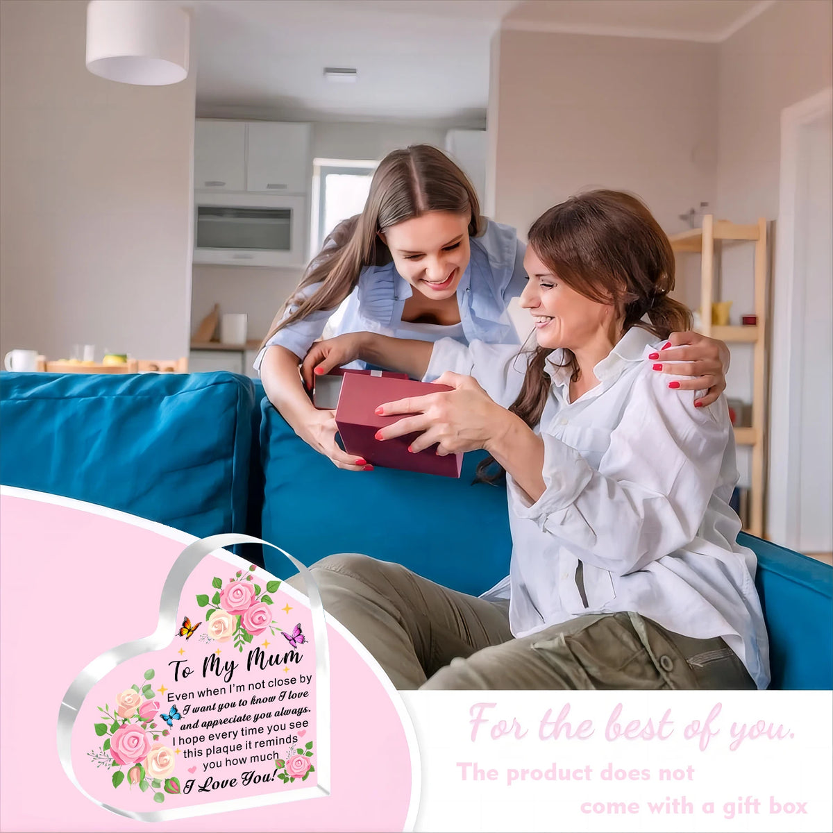 A woman is placing a heartfelt acrylic heart plaque on another woman's chest in a bright living room setting.