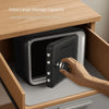 A hand is opening a password-protected piggy bank with a digital lock inside a wooden storage box.