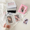 A pink compact photo card holder album with two pages is displayed on a white textured cloth.