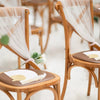 Elegant paper hand fans with gift bags and thank you cards displayed on wooden chairs.