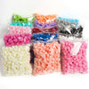 Assortment of colorful PE foam artificial rose flowers in various shades and colors packaged in clear plastic bags.