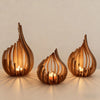 Handcrafted wooden lotus candle holder with a flame, displayed on a light surface.