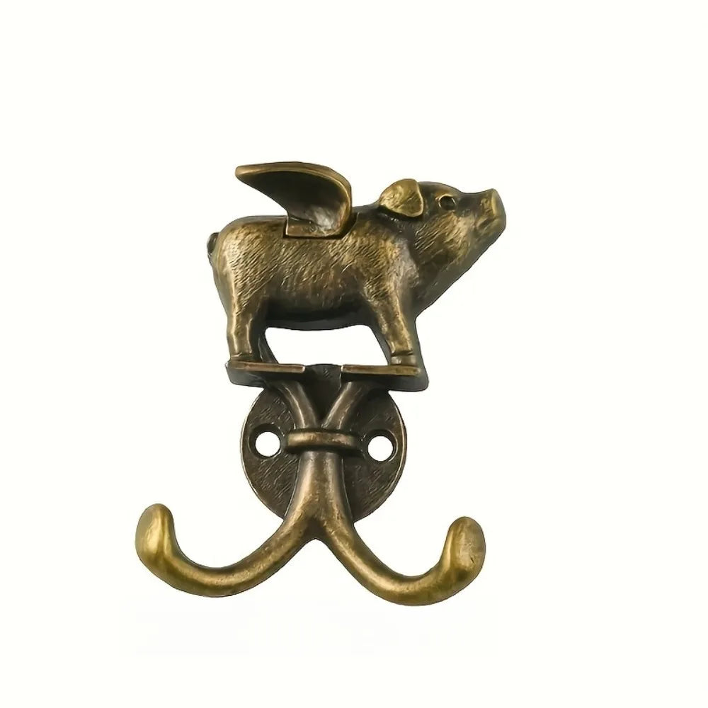 A decorative metal wall hook shaped like a stylized rodent, used for kitchen or bathroom items.