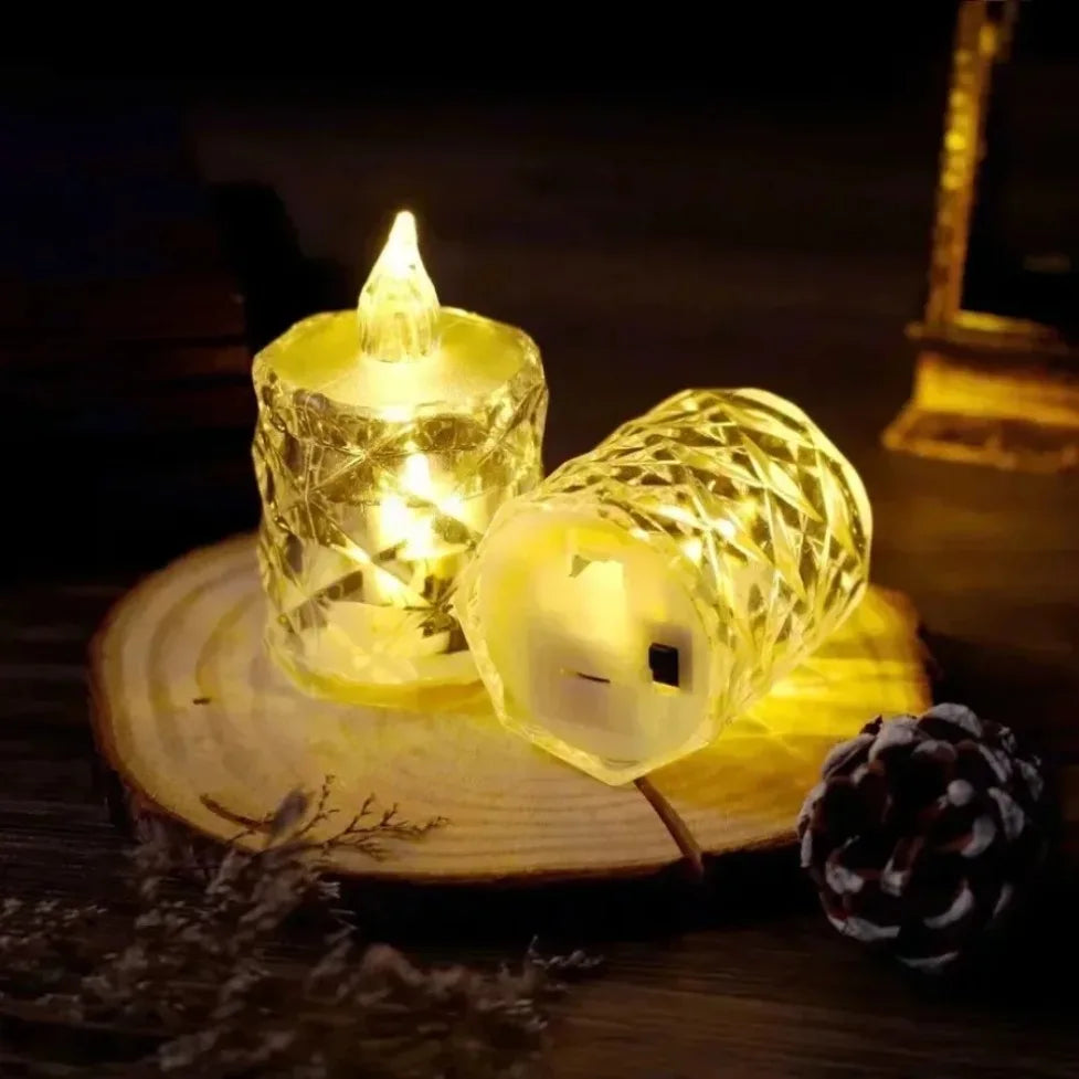 A close-up of glowing yellow LED crystal candles set on a wooden surface with pine needles.