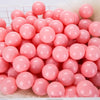 A pile of pink and white spherical balls for kids play areas