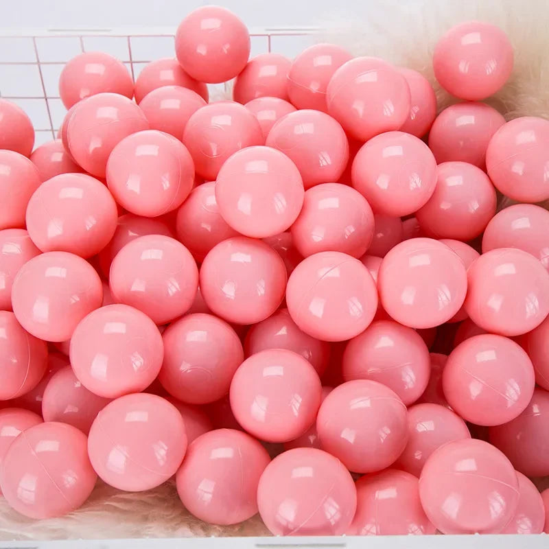 A pile of pink and white spherical balls for kids play areas