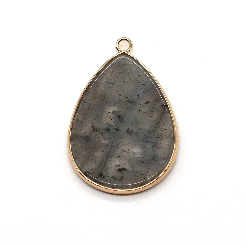 A teardrop-shaped natural agate pendant charm with a gold-toned bezel and rose quartz accents.