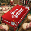 A red Christmas poinsettia rectangle tablecloth displayed on a wooden table with festive holiday decorations.