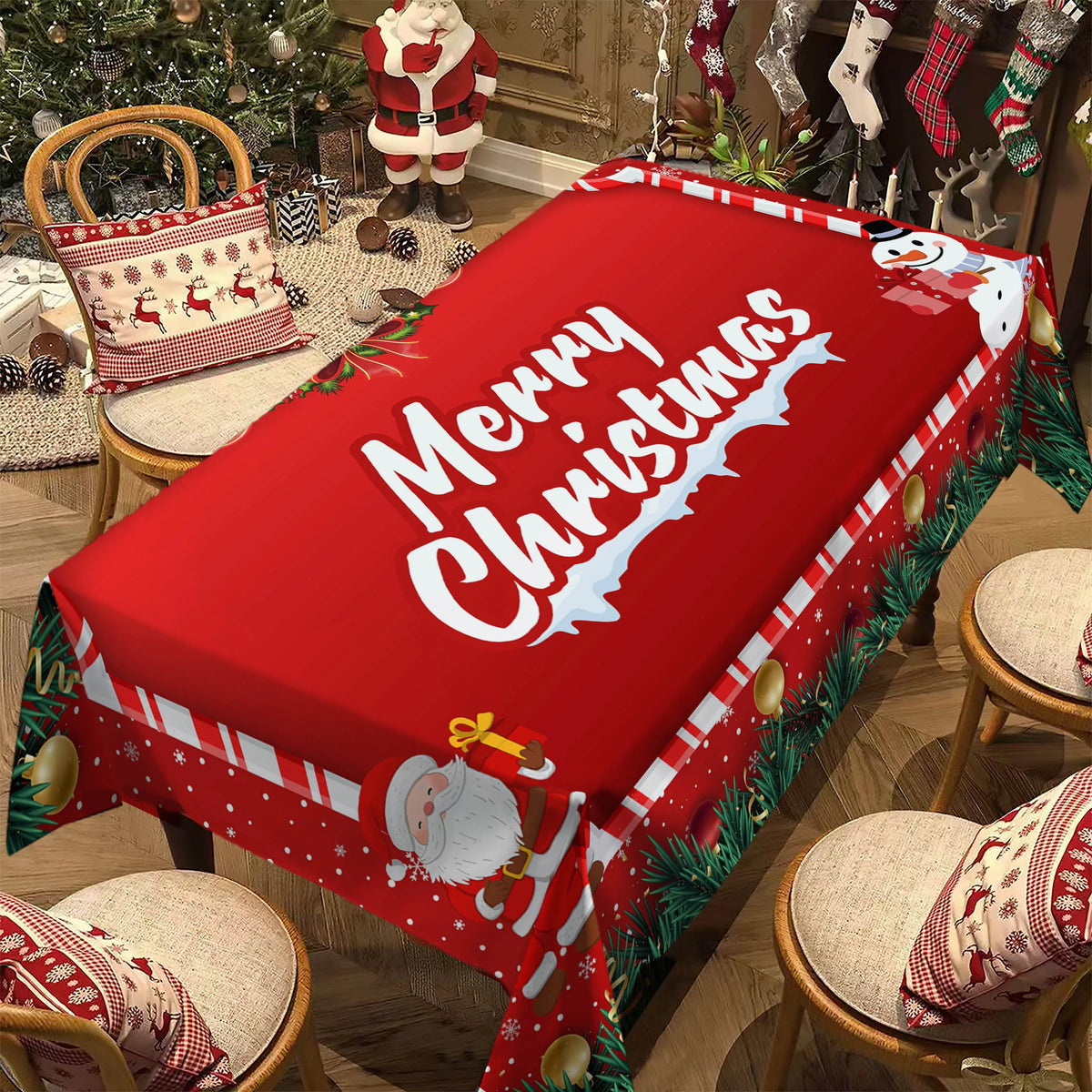 A red Christmas poinsettia rectangle tablecloth displayed on a wooden table with festive holiday decorations.