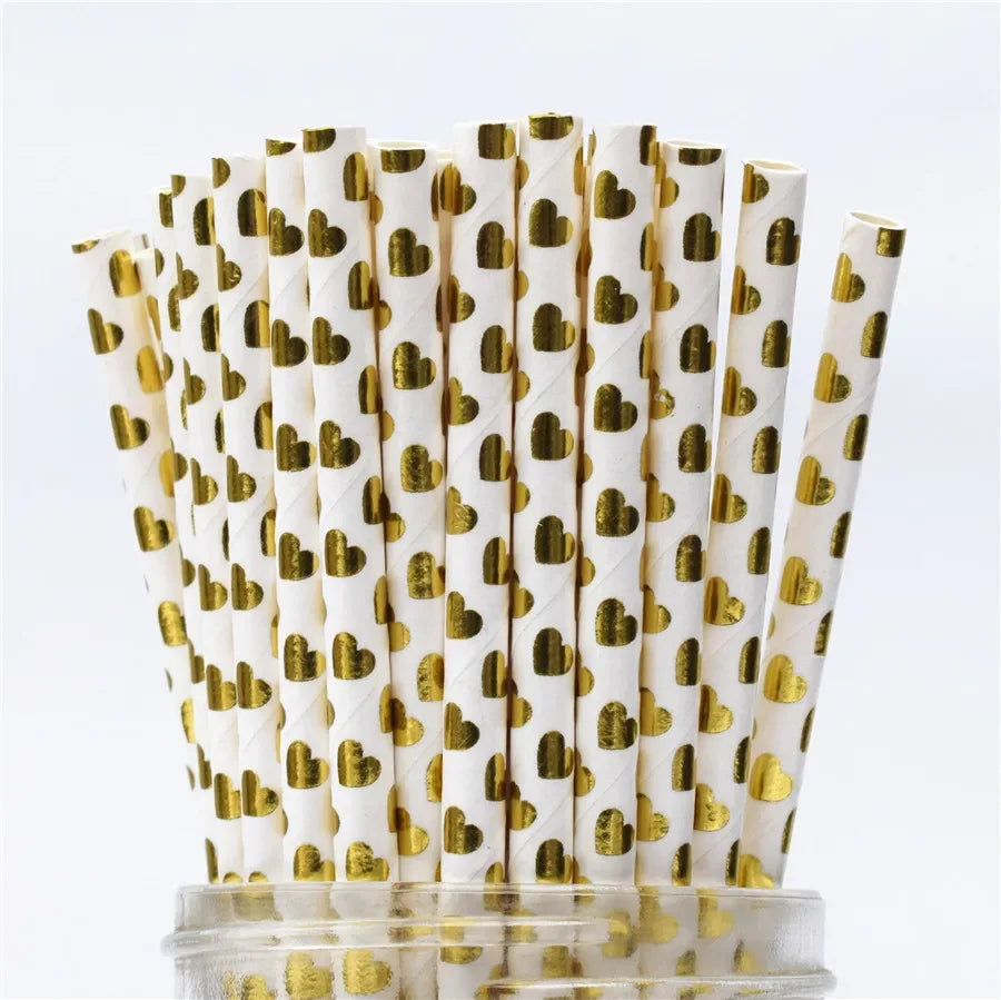 A pack of white drinking straws decorated with gold heart patterns and thin stripes.