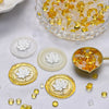 A collection of transparent wax sealing beads in yellow and amber tones, including a glass bowl and circular molds.