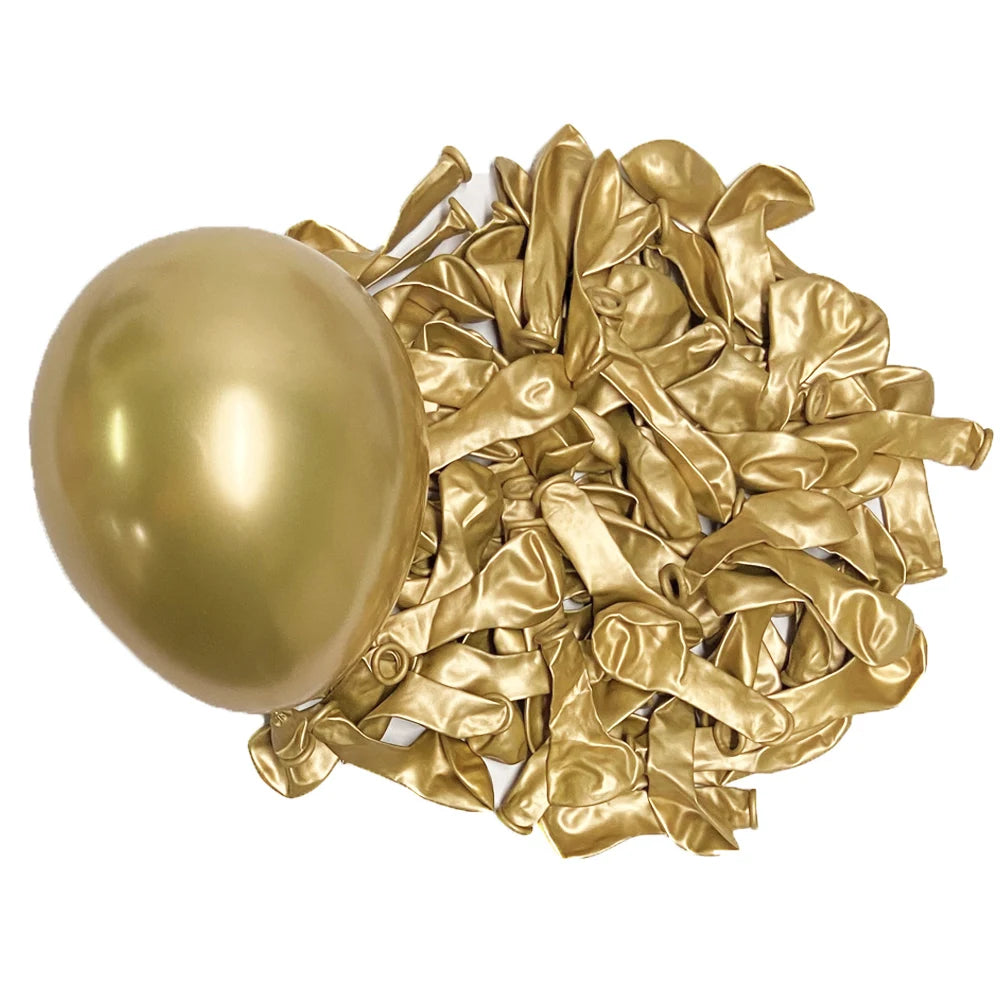 A golden latex balloon next to a pile of crumpled gold foil streamers.