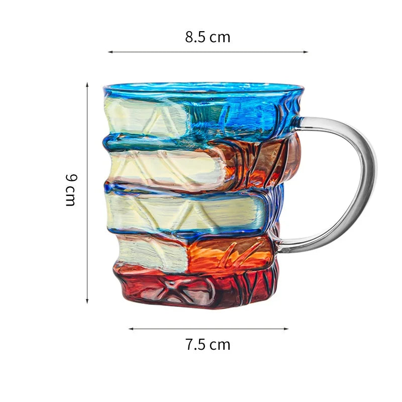 Hand-painted book design mug featuring layered blue, white, and reddish-brown designs.