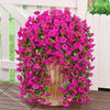 A vibrant display of artificial morning glory hanging vines in bright pink and magenta flowers