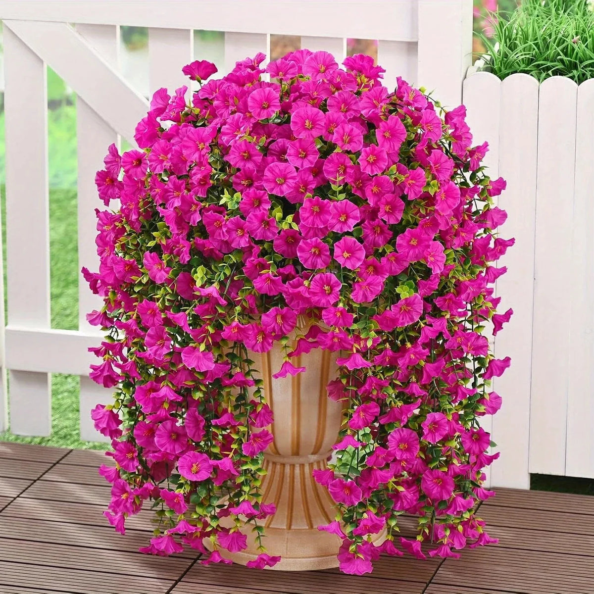 A vibrant display of artificial morning glory hanging vines in bright pink and magenta flowers
