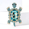 Vintage marine life brooch pin set featuring a gold-toned starfish with blue and teal gemstones