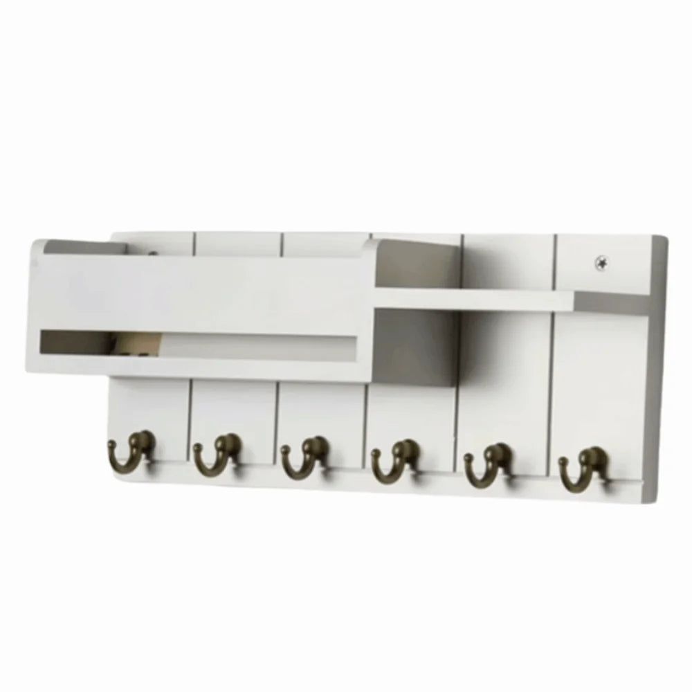 A white wooden key holder with six hooks and a mail sorter slot.