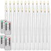 A collection of white flameless LED taper candles with remote timers displayed in a row.