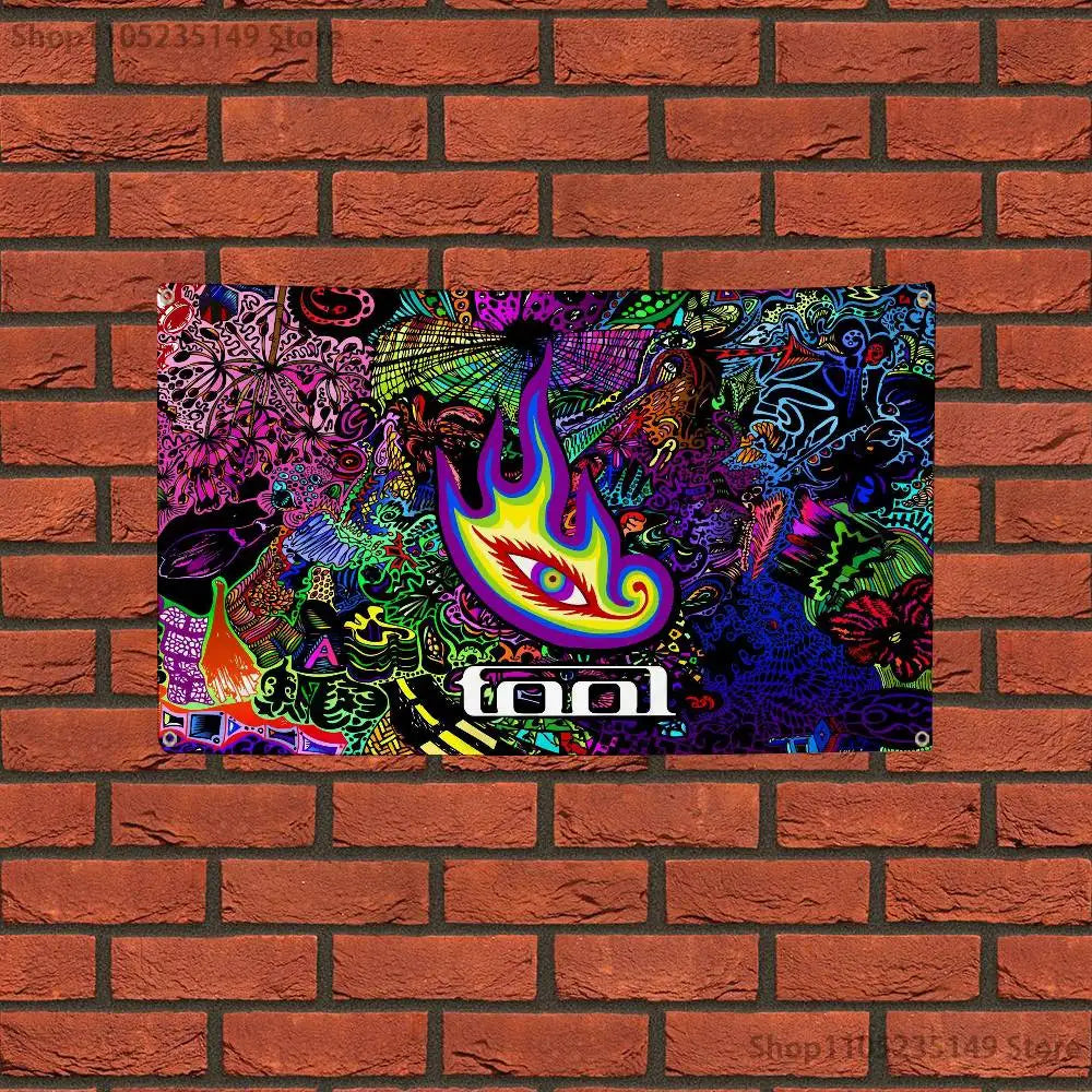 A colorful tapestry featuring a stylized flame design and abstract patterns, displayed against a brick background.