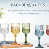 A pack of 12 or 24 reusable plastic wine glasses displayed next to a bottle and flowers.