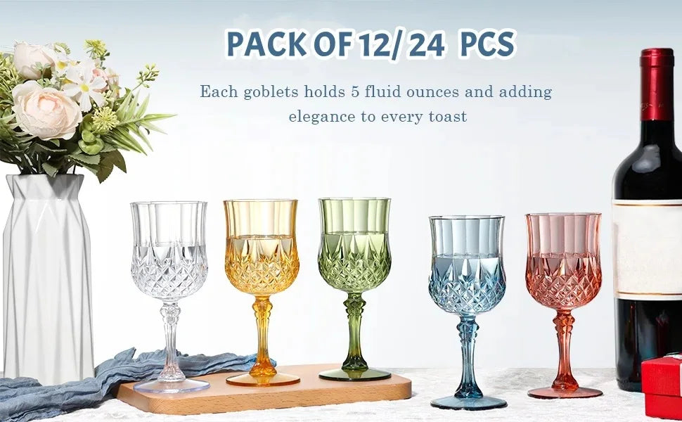 A pack of 12 or 24 reusable plastic wine glasses displayed next to a bottle and flowers.