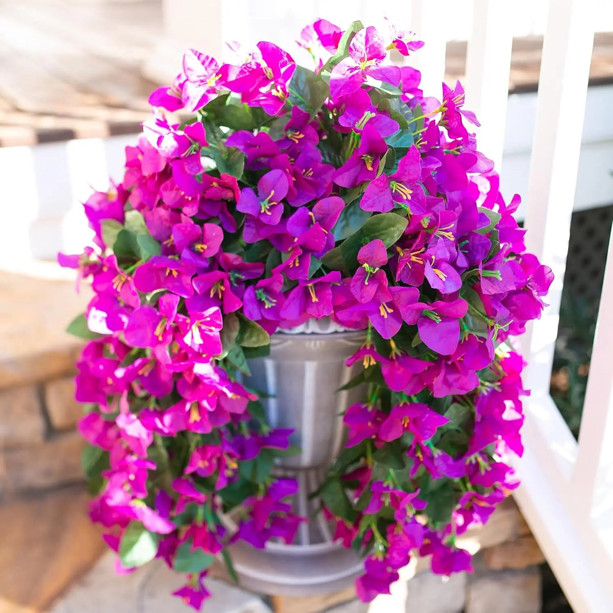 A vibrant purple artificial bougainvillea vine garland displayed in a pot for home or wedding decor.