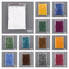 A grid of ten small plastic containers filled with various colored sand pigments for candle wax making.