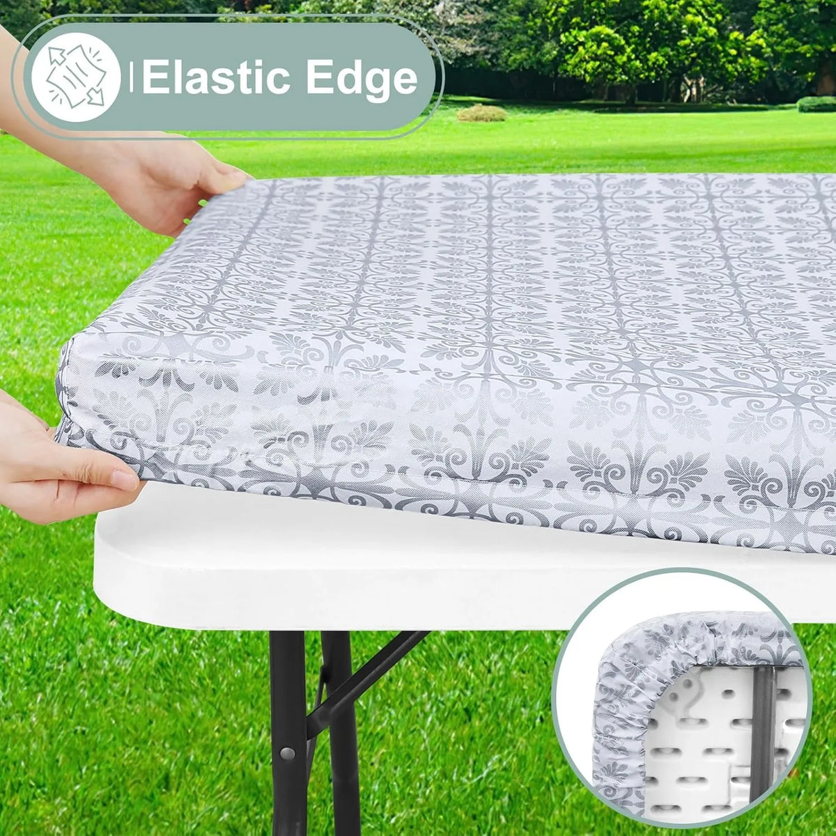 A hand is placing an elastic edge tablecloth onto a white table, showing the fitted rectangle fabric and the elastic edge det